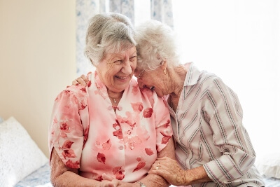 Older women laughing inside