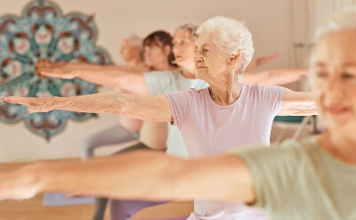 Older people practising yoga