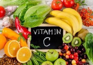 Colourful selection of fruit with a sign that says 'vitamin C' in the centre