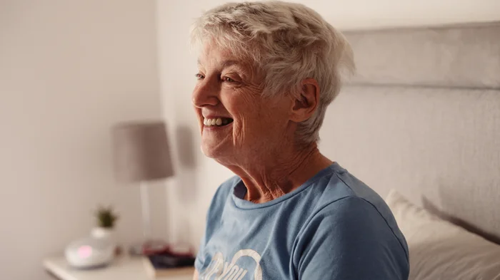 Older woman smiling in bed