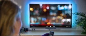 Back of a woman watching TV