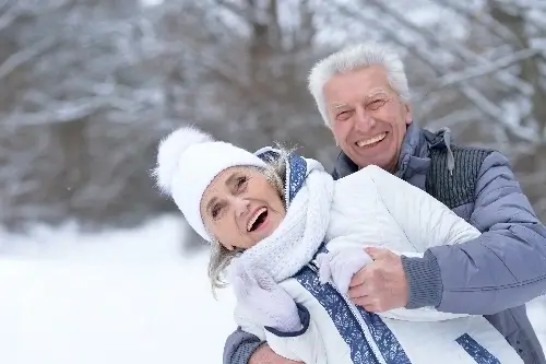 Older couple laughing in the snow