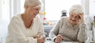 Elderly lady and daughter looking at paperwork