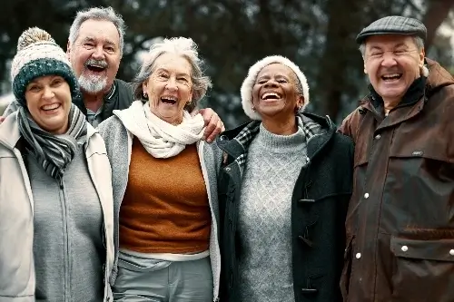 Group of elderly people laughing outside
