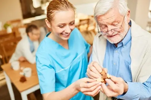 Elderly man and carer
