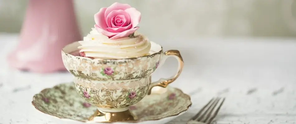 Vintage flowery teacup on white table