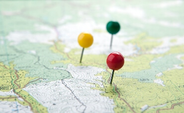 Multi coloured pins stuck in a map